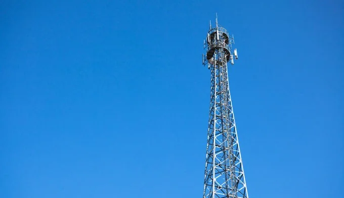 Cellular antenna tower against a blue sky