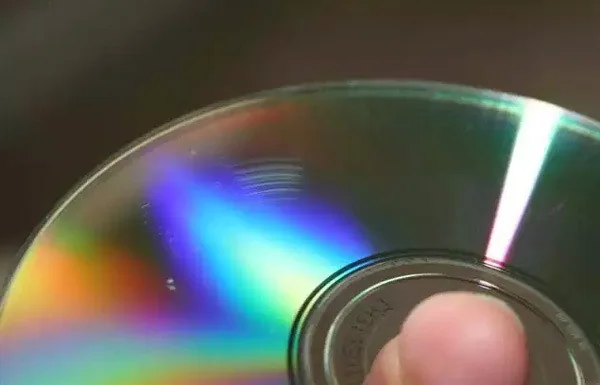 How to Recover Data from Scratched or Damaged CD /DVD’s Scratched optical disc held up to the light.