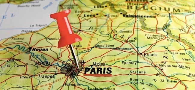 Folded paper map with a red location pin