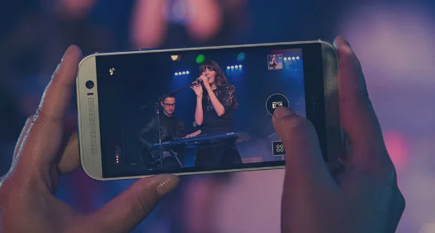HTC One M9 vs iPhone 6 comparison Person watching a video on a smartphone
