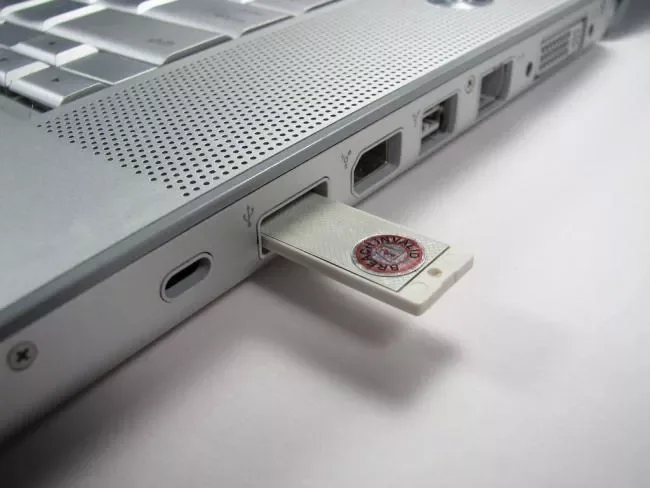 MicroSD card inserted into the side of a laptop