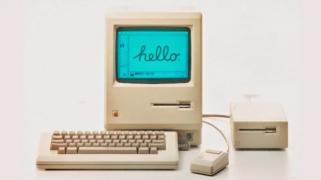 Vintage Macintosh computer with keyboard and mouse